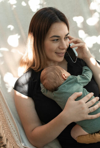 woman with baby talking on phone