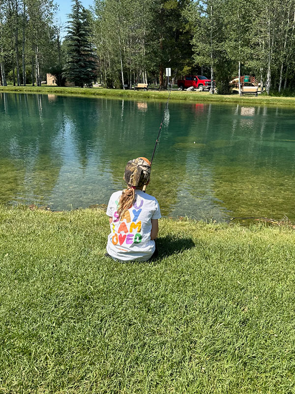 photo of a young person fishing